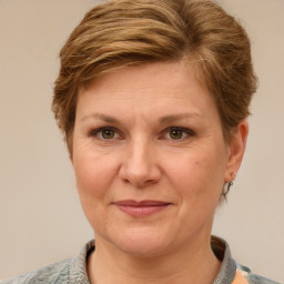 Joyful white adult female with short  brown hair and grey eyes