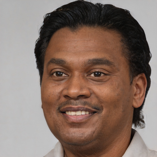 Joyful latino adult male with short  black hair and brown eyes