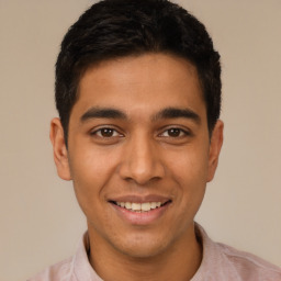 Joyful latino young-adult male with short  black hair and brown eyes