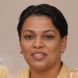 Joyful black adult female with short  brown hair and brown eyes