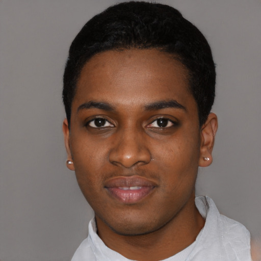 Joyful black young-adult male with short  black hair and brown eyes