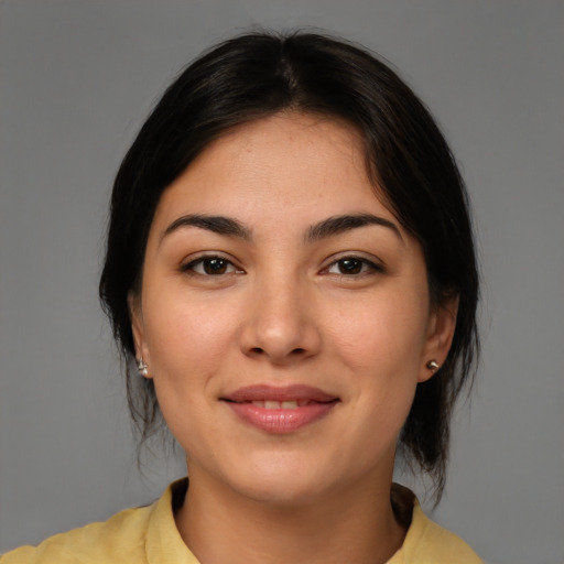 Joyful latino young-adult female with medium  brown hair and brown eyes