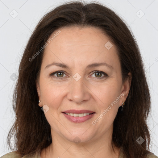 Joyful white adult female with long  brown hair and brown eyes