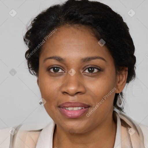 Joyful black adult female with medium  brown hair and brown eyes