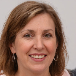 Joyful white adult female with long  brown hair and grey eyes