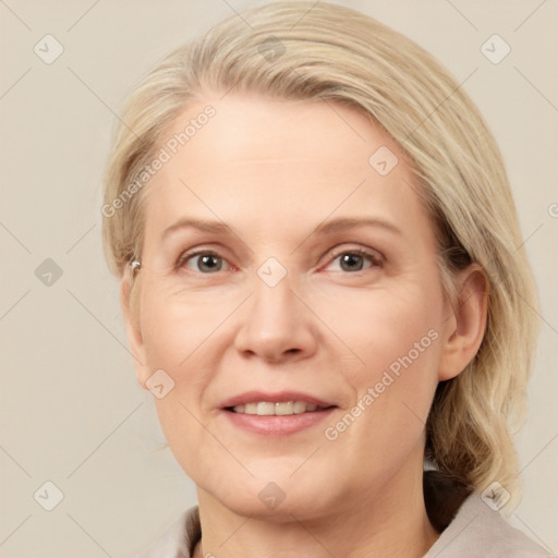 Joyful white adult female with medium  brown hair and blue eyes