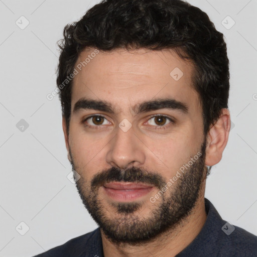 Joyful white young-adult male with short  black hair and brown eyes