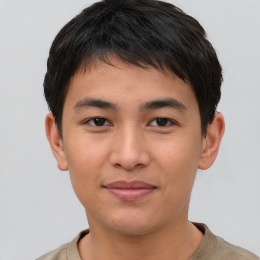 Joyful asian young-adult male with short  brown hair and brown eyes