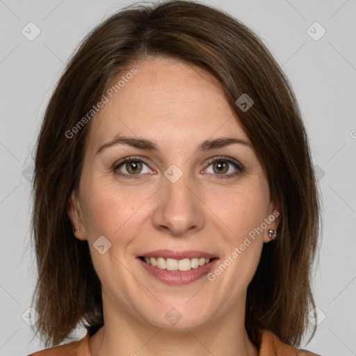 Joyful white adult female with medium  brown hair and grey eyes