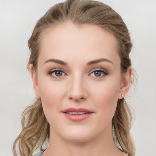 Joyful white young-adult female with long  brown hair and blue eyes