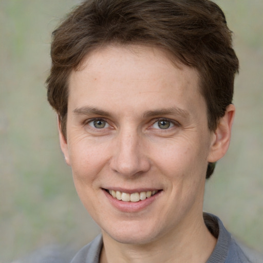 Joyful white adult female with short  brown hair and grey eyes