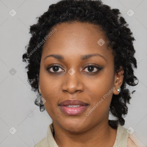 Joyful black young-adult female with long  black hair and brown eyes