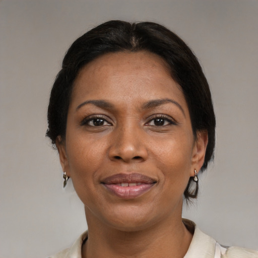 Joyful black adult female with medium  black hair and brown eyes