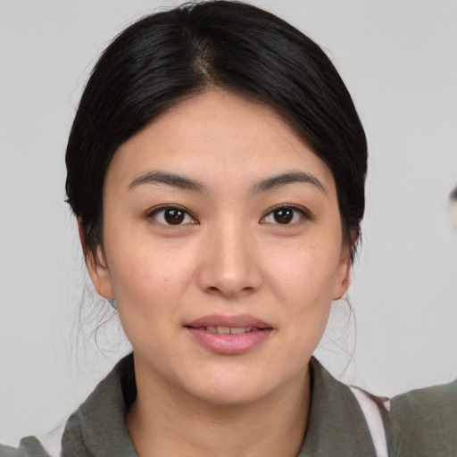Joyful white young-adult female with medium  black hair and brown eyes