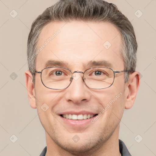 Joyful white adult male with short  brown hair and grey eyes