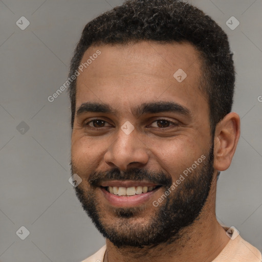 Joyful black young-adult male with short  black hair and brown eyes