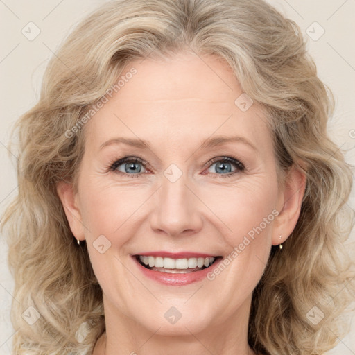 Joyful white adult female with medium  brown hair and blue eyes