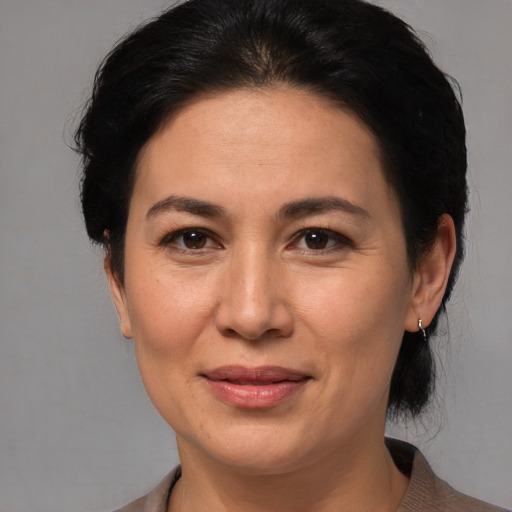 Joyful white adult female with medium  brown hair and brown eyes