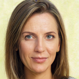 Joyful white adult female with long  brown hair and green eyes