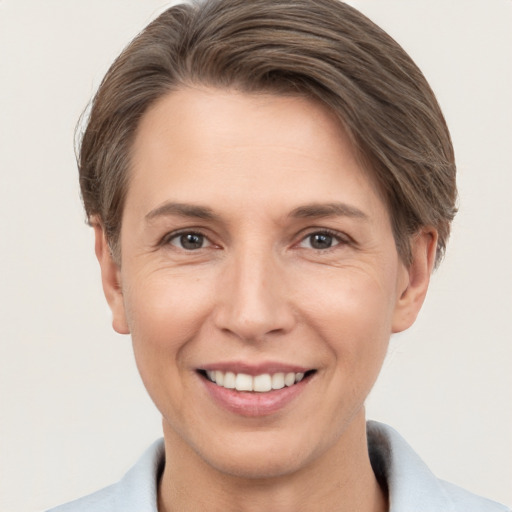 Joyful white adult female with short  brown hair and brown eyes