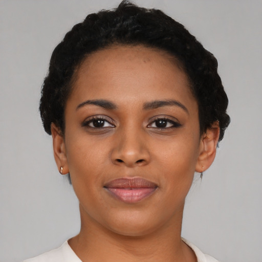 Joyful latino young-adult female with short  black hair and brown eyes