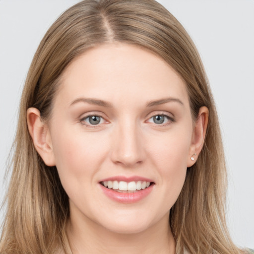 Joyful white young-adult female with long  brown hair and grey eyes