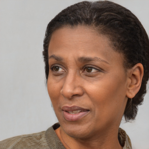 Joyful black adult female with short  brown hair and brown eyes