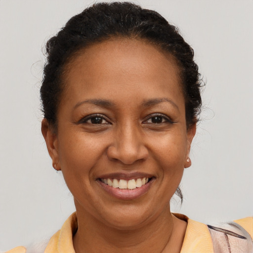 Joyful latino adult female with short  brown hair and brown eyes