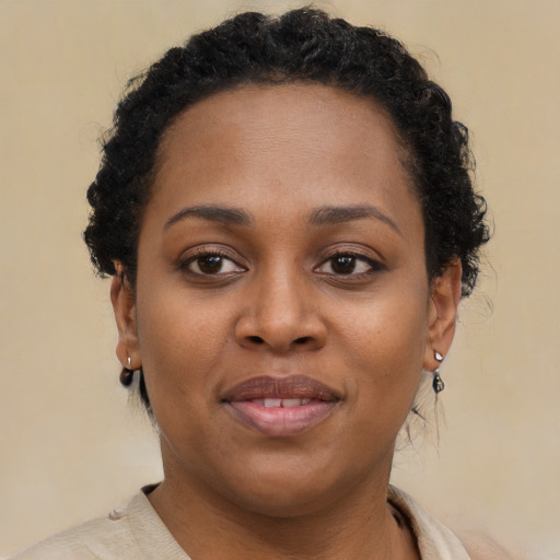 Joyful black young-adult female with short  brown hair and brown eyes