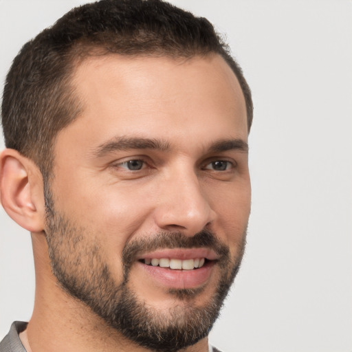 Joyful white young-adult male with short  brown hair and brown eyes