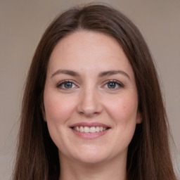 Joyful white young-adult female with long  brown hair and grey eyes