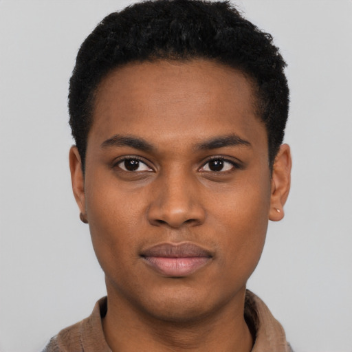 Joyful black young-adult male with short  black hair and brown eyes