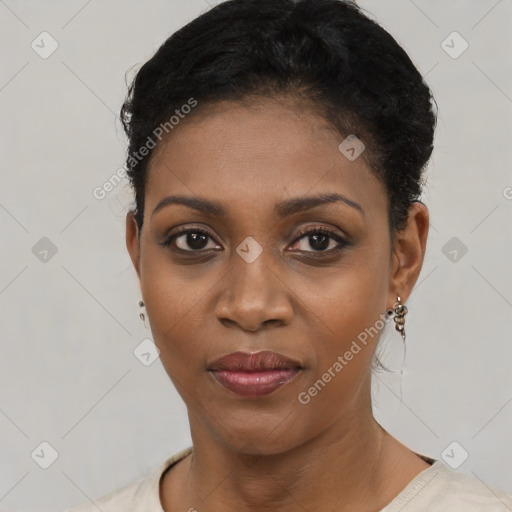 Joyful black young-adult female with short  black hair and brown eyes