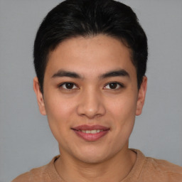 Joyful asian young-adult male with short  brown hair and brown eyes