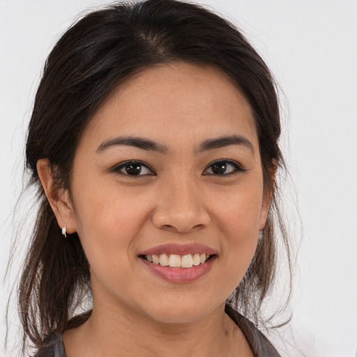 Joyful latino young-adult female with medium  brown hair and brown eyes