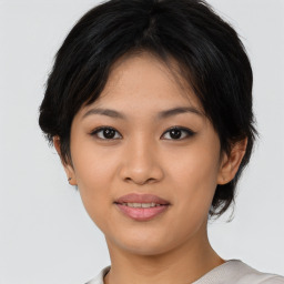 Joyful asian young-adult female with medium  black hair and brown eyes