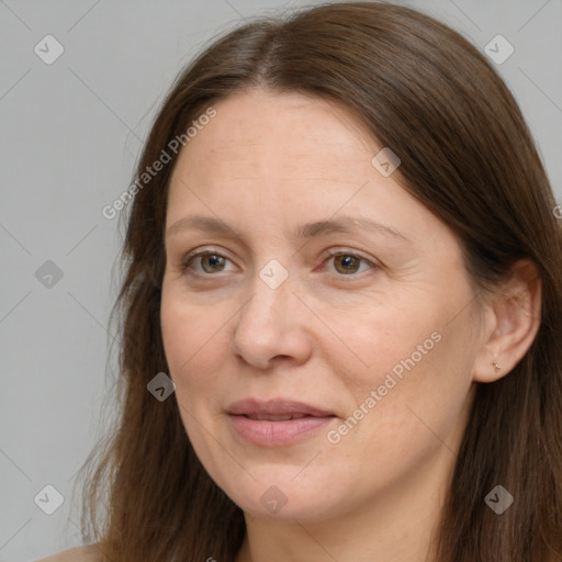 Joyful white adult female with long  brown hair and brown eyes