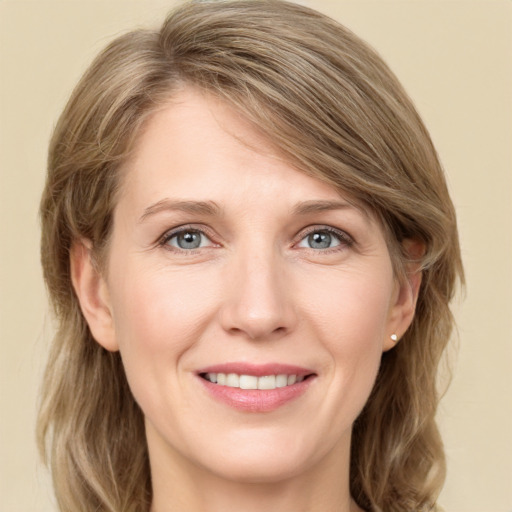 Joyful white young-adult female with medium  brown hair and green eyes