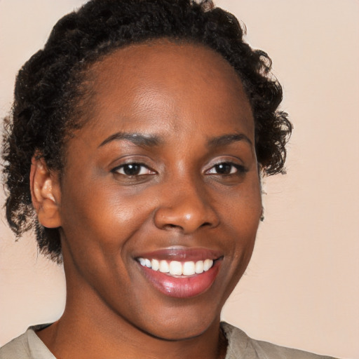 Joyful black young-adult female with medium  brown hair and brown eyes