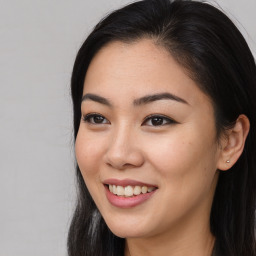 Joyful asian young-adult female with long  brown hair and brown eyes