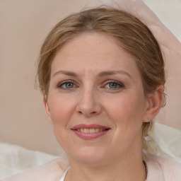 Joyful white adult female with medium  brown hair and blue eyes