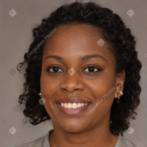 Joyful black young-adult female with medium  brown hair and brown eyes