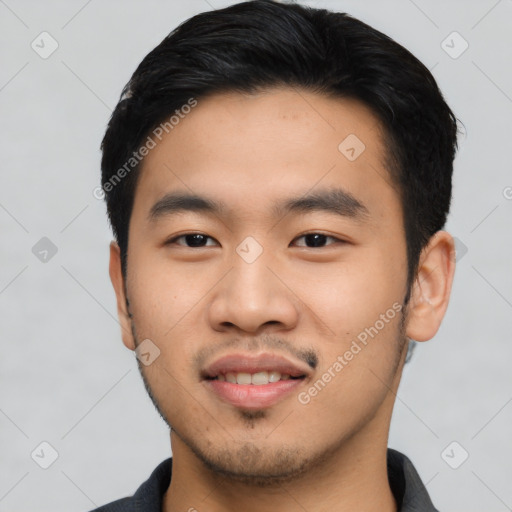 Joyful asian young-adult male with short  black hair and brown eyes