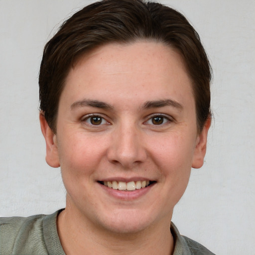 Joyful white young-adult female with short  brown hair and grey eyes