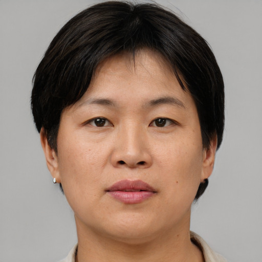 Joyful asian adult female with short  brown hair and brown eyes