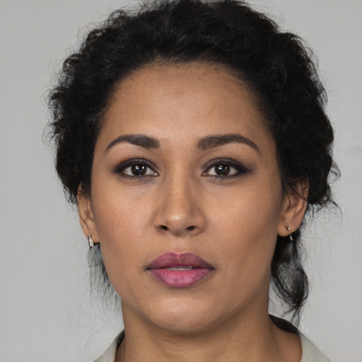 Neutral latino adult female with long  brown hair and brown eyes