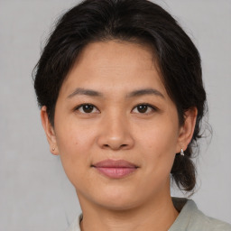 Joyful asian young-adult female with medium  brown hair and brown eyes