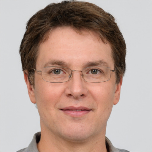 Joyful white adult male with short  brown hair and grey eyes