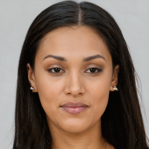Joyful black young-adult female with long  brown hair and brown eyes
