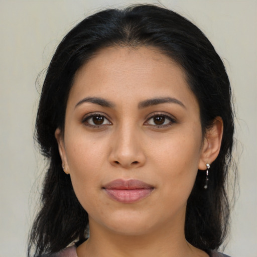 Joyful latino young-adult female with medium  brown hair and brown eyes